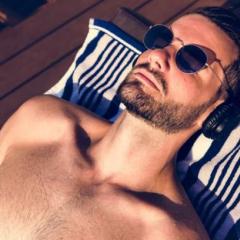 Man tanning on a pool chair
